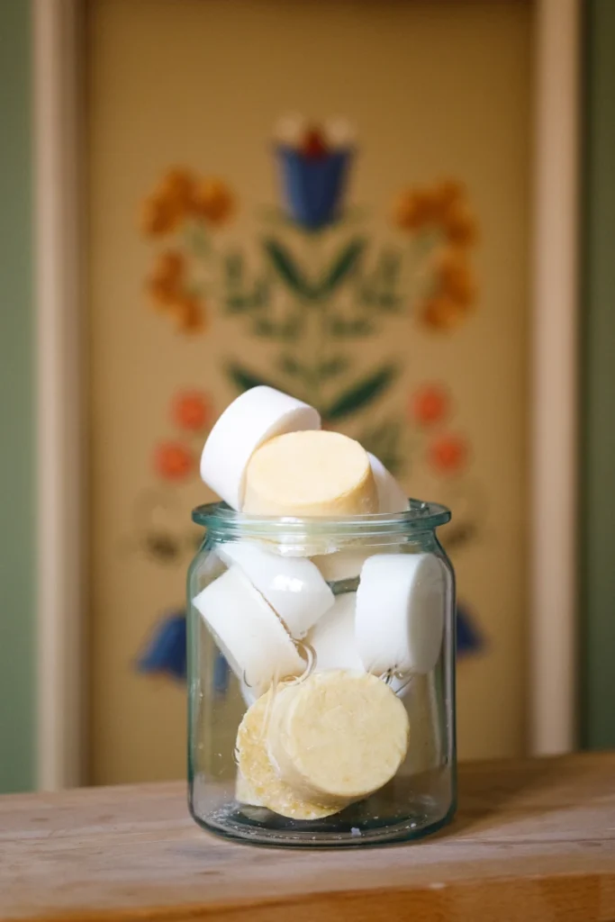 Glas mit gelben und weißen runden Seifenstücken